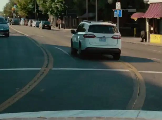 A busy intersection with drivers yielding to pedestrians