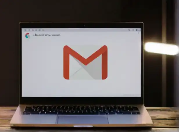 A computer screen with a Gmail inbox filled with emails being deleted rapidly
