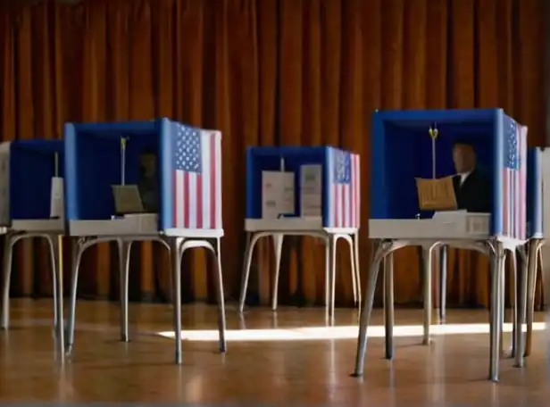 Citizens casting ballots at voting booths with democracy flags