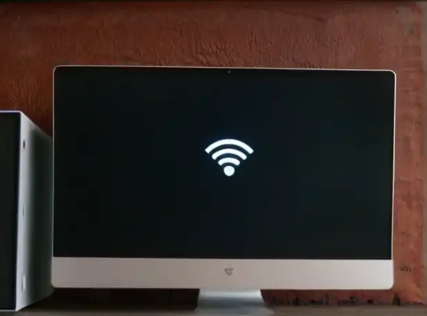 A laptop screen displaying Wi-Fi settings with a magnifying glass icon