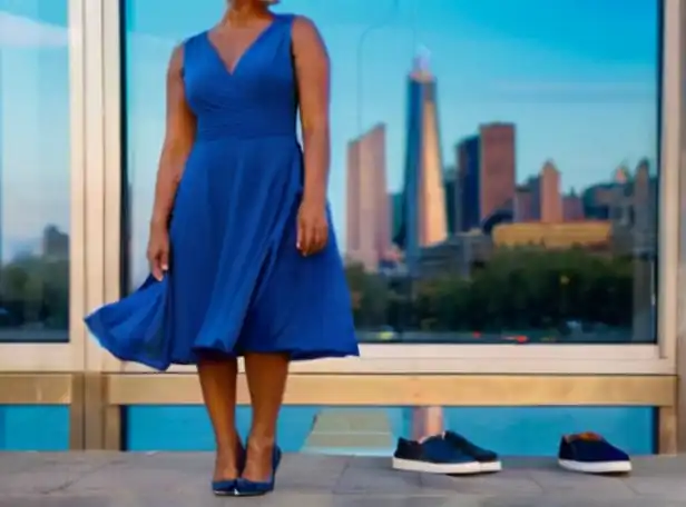 Blue dress with oil-slick shoes in a modern cityscape