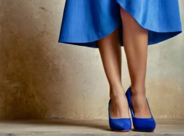 Stylish woman combining blue dress with colorful shoes