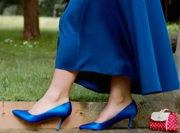 Blue dress model pairing shoes with accessories