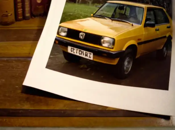 Car insurance paperwork on a desk surrounded by family photos