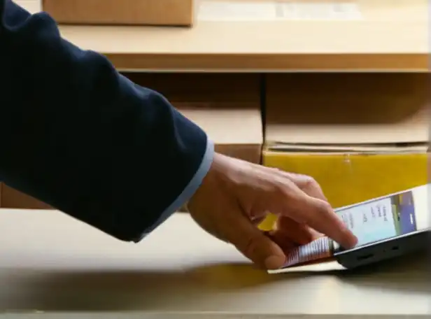 A person checking package tracking online at a desk