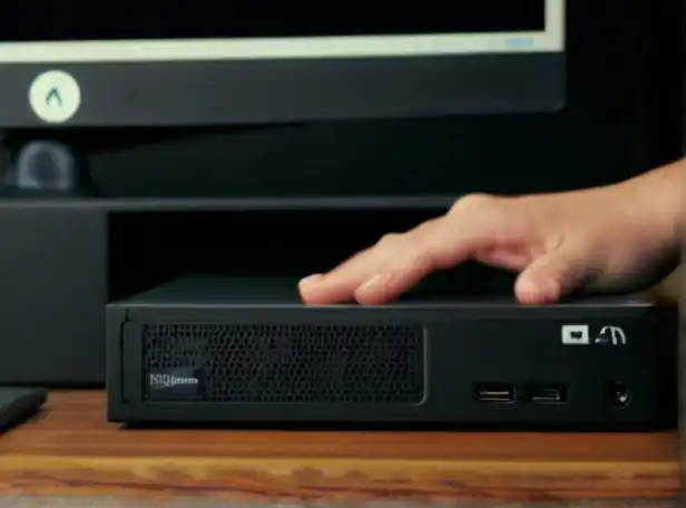 A person holding a computer with a clean disk drive icon