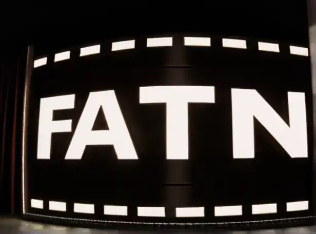 A dark screen with flashing film reels and a faintly lit cinema logo