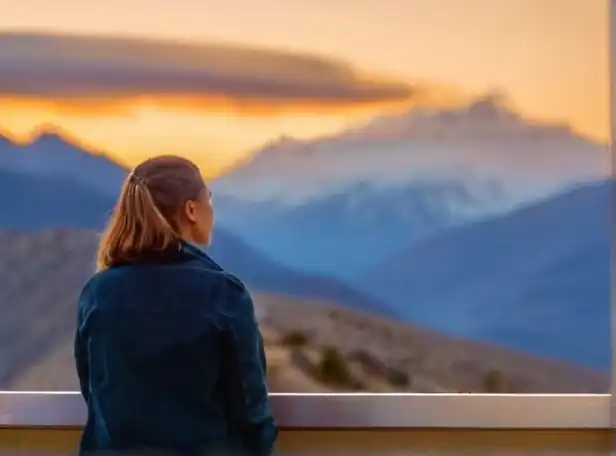 A grateful person looking at a sunset mountain range