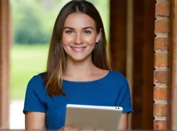 Young adult smiling holding printed document with digital tablet