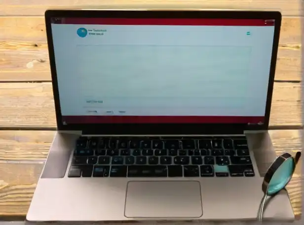 A laptop screen displaying a blank search bar with a magnifying glass and thought bubbles