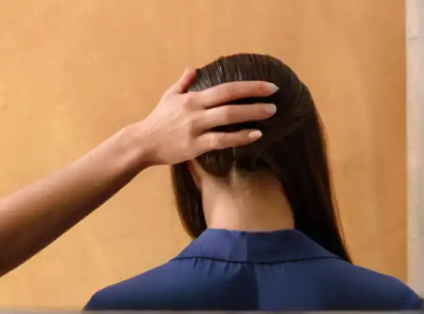 A woman gently massaging a scalp with a hair mask