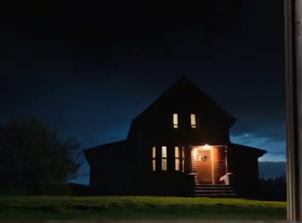 Dark house with flashlight shining through