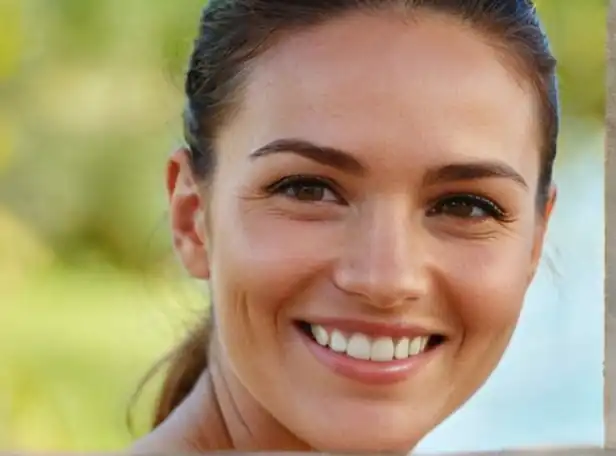 A person smiling with smooth face in a natural setting