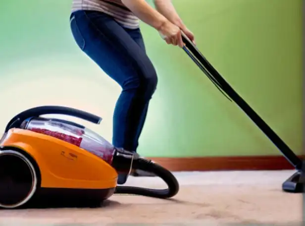 A woman holding a vacuum cleaner cord