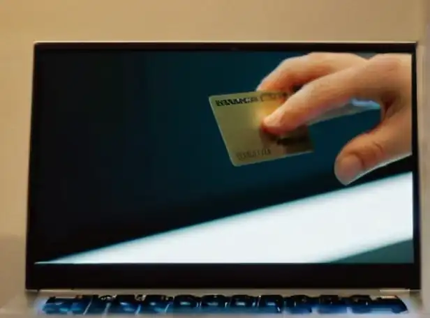 Blocked credit card stuck in a computer screen with frustrated hands