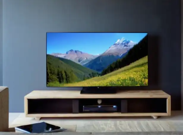 A person watching a smart TV on a couch with a remote control